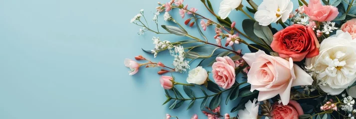 Foto auf Acrylglas floral arrangement of different flowers on a blue background © InfiniteStudio