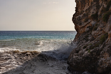 Large waves breaking over rocks - 738921130