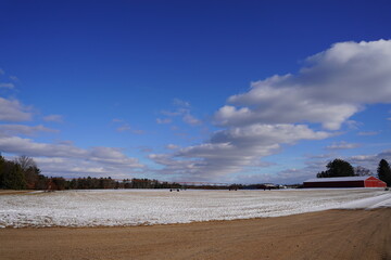 Farmland covered in snow during the winter.