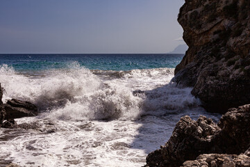 Waves breaking over rocks in Sicily - 738922523