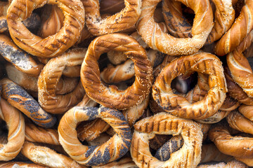 Ruddy baked bagels sprinkled with poppy seeds and sesame seeds.