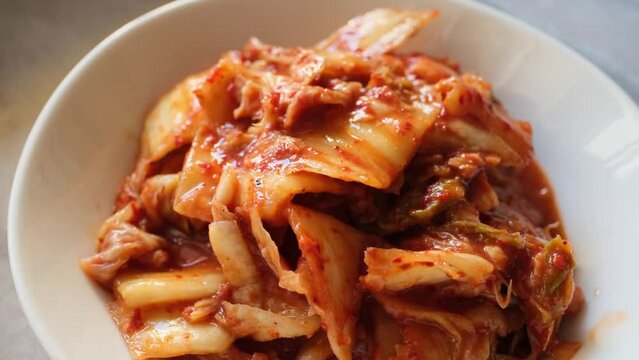 kimchi in fresh white bowl close-up on gray background	