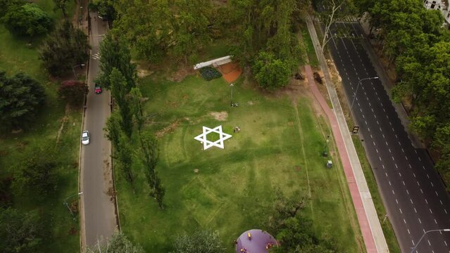 Drone flies over the park with the Star of David, top view