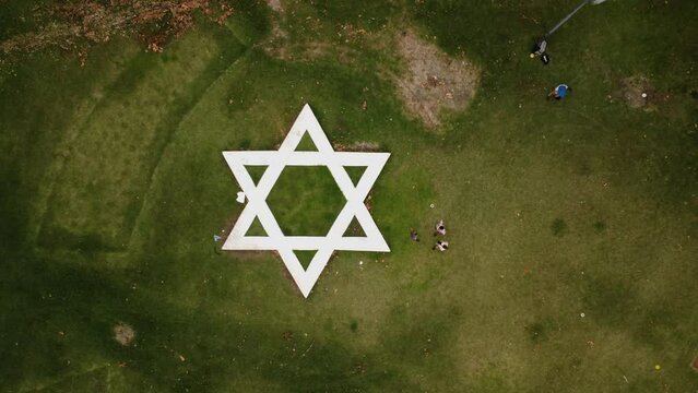 Zoom in to the Star of David on the square, top view from a drone