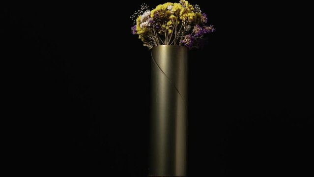No war concept flowers in a vase made from militarry artillery ammunition casing shell guided artillery projectile EXCALIBUR