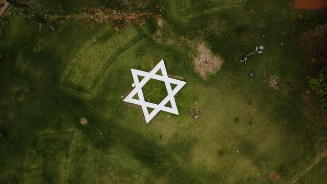 Zoom in with a turn to the Star of David on the square, top view, drone