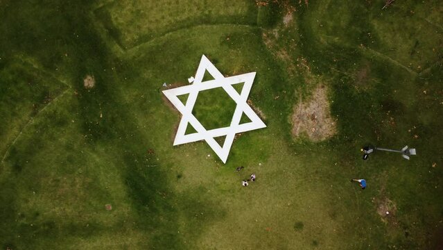 Zoom out from the Star of David on the square, long shot