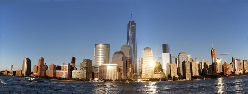 Gorgeous view of the Manhattan skyline with the Freedom Tower over a calm sea on a sunny day