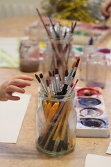 Children paint with pencel and paint. Art in preschool.