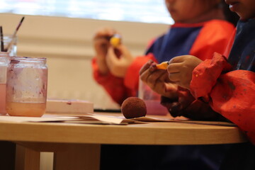 children with brushes. Children paint with paint.