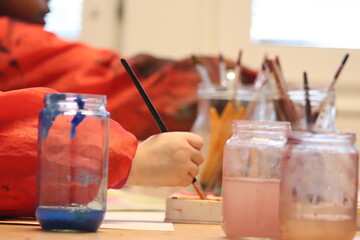 children with brushes. Children paint with paint.