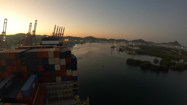 Manzanillo, Mexico - 23.05.2023 Timelapse of container ship arrive to the port and has loading operations with few gantry cranes in Manzanillo Container Terminal.