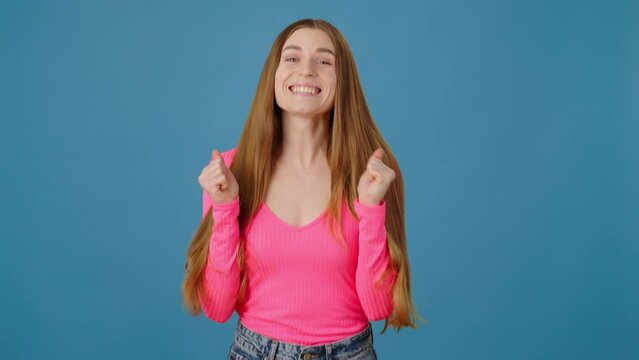 Portrait of extremely happy positive woman rejoicing with raised clenched fists, winning lottery