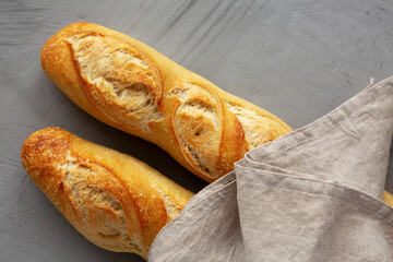 Homemade French Bread Baguette on a gray background, top view.