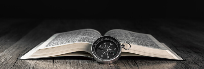 Book and compass on the table