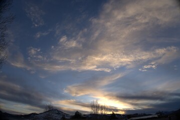 Fototapeta na wymiar Mountain Sunset with Cloud Cover
