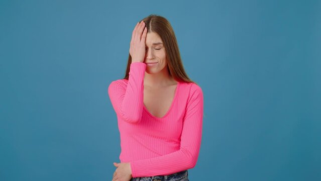 Portrait of unlucky girl making facepalm gesture, feeling regret and sorrow