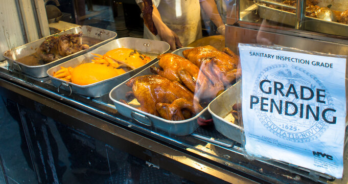  Close Up Shot Of Sanitary Inspection Grade Label On The Window Of A Chinatown Restaurant. 