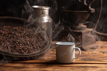 Coffee, white coffee mug on rustic wood and accessories, dark background, selective focus.