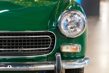 Headlight of an oldtimer green car - Powered by Adobe