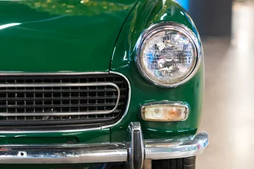 Foto auf Acrylglas Headlight of an oldtimer green car © ZenitX