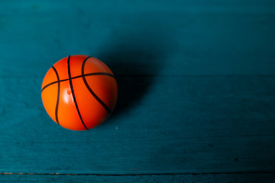 Toy basketball on a blue wooden background