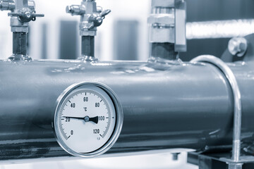 Pipes and taps in water supply boiler room, engineering industrial background