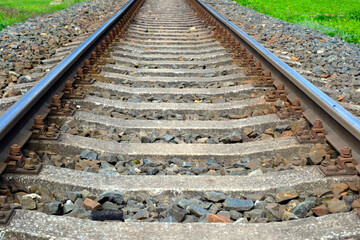 Track, two rails supporting and guiding the wheels of rail vehicles, placed on sleepers in a special concrete slab, at a specific distance from each other, serving as a railway