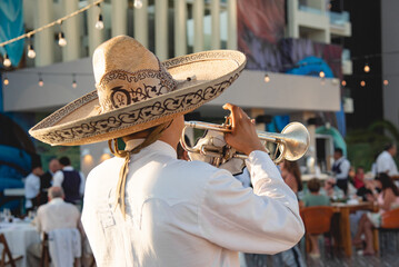 Close up of Mexican Mariachi,  traditional musical ensemble generally made up of a minimum number of three members; generally using guitar, guitar, violin and trumpets