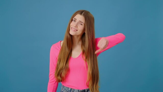 Portrait of sad disappointed woman with long hair standing showing dislike gesture