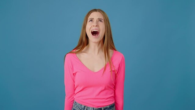 Portrait of angry woman with long hair screaming with hate and aggression