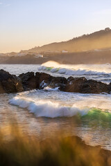 Waves breaking on the sea near the beach at sunset. Meiras, Galicia, Spain.