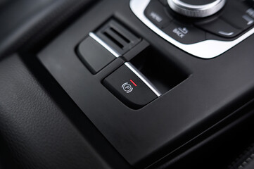 Fototapeta premium Close-Up of Electronic Parking Brake Control: Modern Vehicle Interior with High-Tech Parking Feature