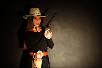 Fototapeta premium Beautiful woman in white hat holding vintage revolver