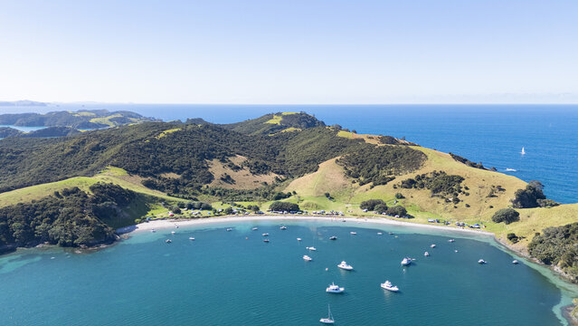Aerial view of a paradisiac beach with some boats in New Zealand