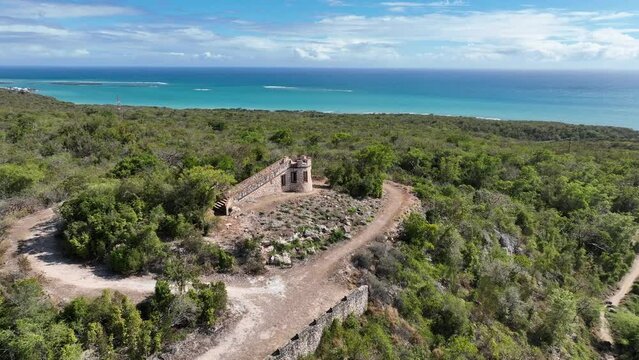 Aerial video of old Spanish fort perched on hill in southern Puerto Rico with Caribbean Sea in background. Drone footage of Fuerte Capr&oacute;n.