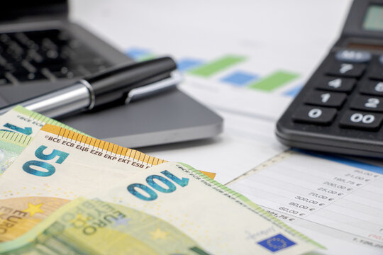 Calculator on finance graphs and euro bills
