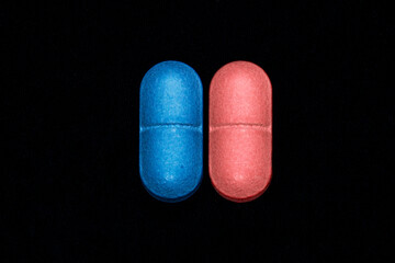 Blue and red pill closeup on black background	
