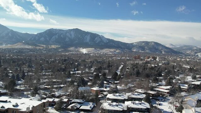 A slow pan across the picturesque city of Boulder, Colorado, with the majestic Flatirons towering in the background.