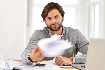 Portrait, frustration and businessman throwing documents at desk in office with annoyed or moody...