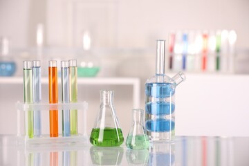 Laboratory analysis. Different glassware with liquids on white table indoors