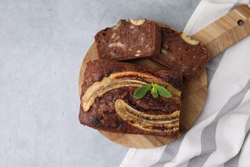 Delicious banana bread on grey table, top view. Space for text