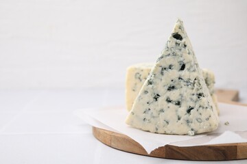Tasty blue cheese on white table, closeup. Space for text