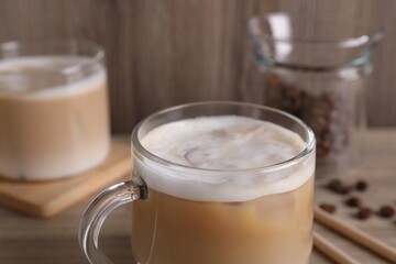Cup of fresh coffee on wooden table, closeup