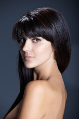 Fototapeta premium Beauty, skincare and portrait of woman with confident skin glow, natural makeup and facial care in studio. Pride, dermatology and luxury cosmetics with face of girl isolated on dark blue background.