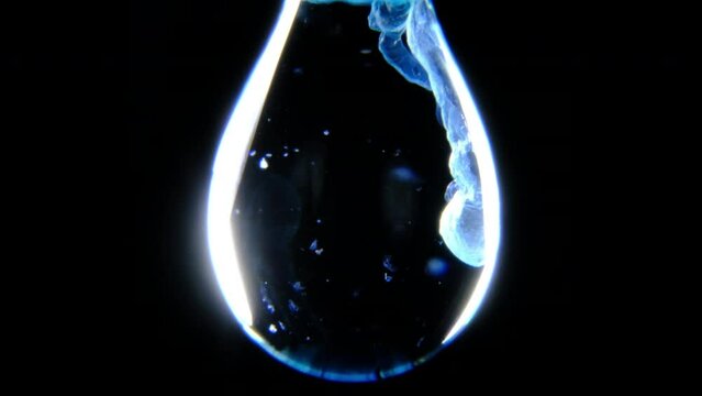 Copper Hydroxide Precipitates in a water drop through a chemical reaction between copper sulphate and sodium hydroxide