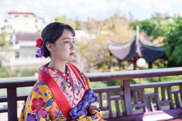 沖縄県那覇市の中国庭園で琉装を着た２０代の若い日本人女性 A young...