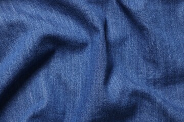 Texture of blue crumpled fabric as background, top view