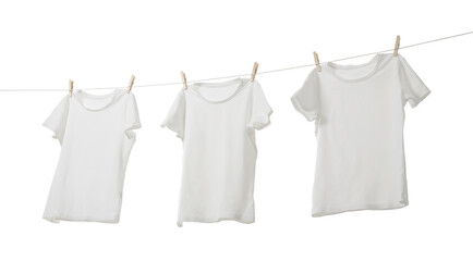 Many t-shirts drying on washing line isolated on white