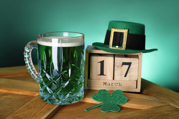 St. Patrick's day celebrating on March 17. Green beer, block calendar, leprechaun hat and...